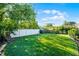 Spacious backyard featuring a well-maintained lawn, mature trees, and a privacy fence at 11730 Kennington Ct, Orlando, FL 32824