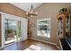 A bright dining room with modern chandelier and natural light streaming in from the window at 11730 Kennington Ct, Orlando, FL 32824