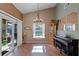 An airy dining room with high ceilings, a chandelier, and a view of the pool at 11730 Kennington Ct, Orlando, FL 32824