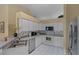 Well-equipped kitchen featuring white cabinets, tile backsplash, and stainless steel appliances at 11730 Kennington Ct, Orlando, FL 32824
