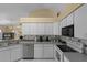 Kitchen boasts ample counter space, white cabinetry, and a tile backsplash at 11730 Kennington Ct, Orlando, FL 32824