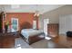 Spacious main bedroom with a large bed, ceiling fan, and natural light at 11730 Kennington Ct, Orlando, FL 32824