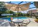 Enjoy outdoor living with a screened-in pool and patio area, perfect for entertaining at 11730 Kennington Ct, Orlando, FL 32824