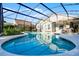Gorgeous screened-in pool with inviting patio and a beautifully landscaped backyard at 11730 Kennington Ct, Orlando, FL 32824