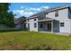 Expansive backyard featuring a well-maintained lawn, exterior of the home and the side of a neighbor's home at 12303 Bohannon Blvd, Orlando, FL 32824