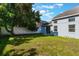 Green backyard with lush grass, a large tree, and a white fence, perfect for outdoor relaxation at 12303 Bohannon Blvd, Orlando, FL 32824