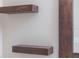 Bathroom accent with custom wood shelving to compliment the wood-trimmed mirror on a light-colored wall at 12303 Bohannon Blvd, Orlando, FL 32824