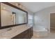 Bathroom with double sink vanity, shower, and large soaking tub at 12303 Bohannon Blvd, Orlando, FL 32824