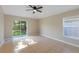 Spacious bedroom with a sliding glass door to the backyard and a ceiling fan at 12303 Bohannon Blvd, Orlando, FL 32824