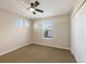 A cozy bedroom featuring a ceiling fan, and natural lighting through a window at 12303 Bohannon Blvd, Orlando, FL 32824