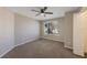 Simple bedroom with carpet flooring, ceiling fan, window, and a closet at 12303 Bohannon Blvd, Orlando, FL 32824
