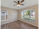 Light bedroom with wood flooring, ceiling fan and a large window with outside view at 12303 Bohannon Blvd, Orlando, FL 32824