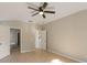 Neutral bedroom with a ceiling fan, and access to a bathroom and closet at 12303 Bohannon Blvd, Orlando, FL 32824