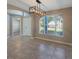Elegant dining area with a modern chandelier and tile flooring, great for entertaining at 12303 Bohannon Blvd, Orlando, FL 32824