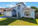 Stylish two-story home boasting an attached garage and lush green lawn at 12303 Bohannon Blvd, Orlando, FL 32824