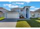 Charming two-story home with a well-manicured lawn, attached garage, and inviting front entrance at 12303 Bohannon Blvd, Orlando, FL 32824