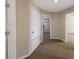 Hallway with carpet and neutral walls, leading to bedrooms and other rooms at 12303 Bohannon Blvd, Orlando, FL 32824