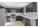 Contemporary kitchen featuring stainless steel appliances and sleek black cabinets at 12303 Bohannon Blvd, Orlando, FL 32824