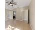 Neutral living room showcasing tile floors, ceiling fan, and a glimpse into the bathroom at 12303 Bohannon Blvd, Orlando, FL 32824