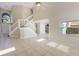 Bright living room with tile flooring, high ceilings, staircase, and large windows at 12303 Bohannon Blvd, Orlando, FL 32824