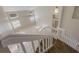 Carpeted stairway leading to a sunlit space with neutral walls and modern ceiling fan at 12303 Bohannon Blvd, Orlando, FL 32824