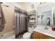 Tidy bathroom features a shower-tub combo, storage shelves, and a single sink vanity at 1321 Artisan E Ave, Celebration, FL 34747