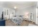 Bedroom with patterned bedding, white furniture, crown molding, and natural light from shuttered windows at 1321 Artisan E Ave, Celebration, FL 34747