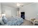 Bedroom with patterned bedding, TV, and a ceiling fan to keep you cool at 1321 Artisan E Ave, Celebration, FL 34747