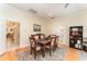 Inviting dining room with wood table set, rug, wood floors, and access to other rooms at 1321 Artisan E Ave, Celebration, FL 34747