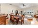 Dining room with wood table, chairs, wood floors, and view into a sitting room at 1321 Artisan E Ave, Celebration, FL 34747
