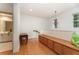 Upstairs hallway with storage bench, chandelier, and a view into the bathroom at 1321 Artisan E Ave, Celebration, FL 34747