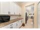 Kitchen featuring white cabinets, granite countertops, and stainless appliances that opens up to dining area at 1321 Artisan E Ave, Celebration, FL 34747