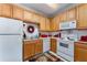 Traditional kitchen with wood cabinets, white appliances, and ample counter space at 1321 Artisan E Ave, Celebration, FL 34747