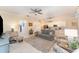 Bright, open-plan living room with kitchen view, featuring a sofa, accent chairs, and neutral decor at 1321 Artisan E Ave, Celebration, FL 34747