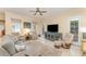 Cozy living room featuring a plush sofa, accent chairs, ceiling fan, and bright natural light at 1321 Artisan E Ave, Celebration, FL 34747