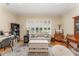Bright living room boasts a neutral color palette, plush sofa, shuttered windows, and stylish decor at 1321 Artisan E Ave, Celebration, FL 34747