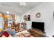 Bright living space featuring a dining table and chairs with an adjacent kitchen at 1321 Artisan E Ave, Celebration, FL 34747