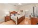 Serene main bedroom with hardwood floors, decorative lamps, and an ensuite bathroom at 1321 Artisan E Ave, Celebration, FL 34747