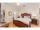 Bedroom with hard wood floors, a bed with many pillows and access to a walk-in closet at 1321 Artisan E Ave, Celebration, FL 34747