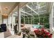 Screened-in patio featuring a cozy seating area, garden beds, and views of the backyard at 1321 Artisan E Ave, Celebration, FL 34747