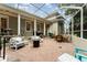 Screened in patio with brick pavers and plenty of comfortable seating with overhead covering at 1321 Artisan E Ave, Celebration, FL 34747