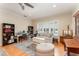Sitting room featuring built-in bookcases, a comfortable sofa, ottoman, and light-filled window at 1321 Artisan E Ave, Celebration, FL 34747