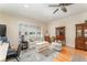 Sitting room featuring built-in bookcases, a comfortable sofa, ottoman, and shuttered window at 1321 Artisan E Ave, Celebration, FL 34747