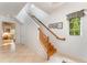 Bright, naturally lit staircase with wood railing and tile flooring in a modern home at 1321 Artisan E Ave, Celebration, FL 34747