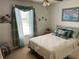 Serene bedroom featuring a comfortable bed, soft lighting, and a picturesque window view at 1410 Sanchez Ct, Lady Lake, FL 32159