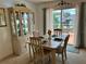 Inviting dining room with a display cabinet, seating for four, and sliding glass doors to the outside patio at 1410 Sanchez Ct, Lady Lake, FL 32159