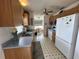 Efficient kitchen with ample wood cabinetry, white appliances, and a convenient layout at 1410 Sanchez Ct, Lady Lake, FL 32159