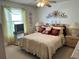 Comfortable main bedroom featuring a decorative headboard, a ceiling fan, and bedside tables at 1410 Sanchez Ct, Lady Lake, FL 32159