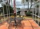 Relaxing screened patio with outdoor seating and a view of the backyard, perfect for outdoor enjoyment at 1410 Sanchez Ct, Lady Lake, FL 32159