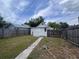 View of backyard with detached garage at the end of a walkway at 1413 11Th St, St Cloud, FL 34769